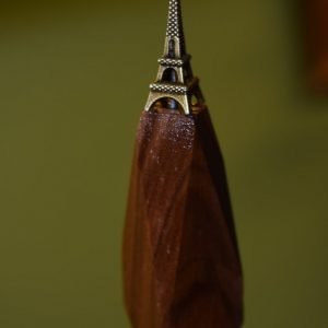 Wooden teak prism with a tiny Eiffel tower on top